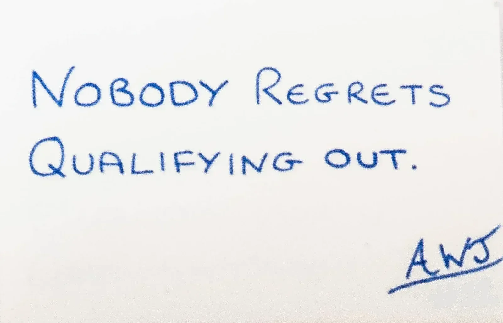 Handwritten in blue ink: Nobody regrets qualifying out. Signed AWJ, number 12.