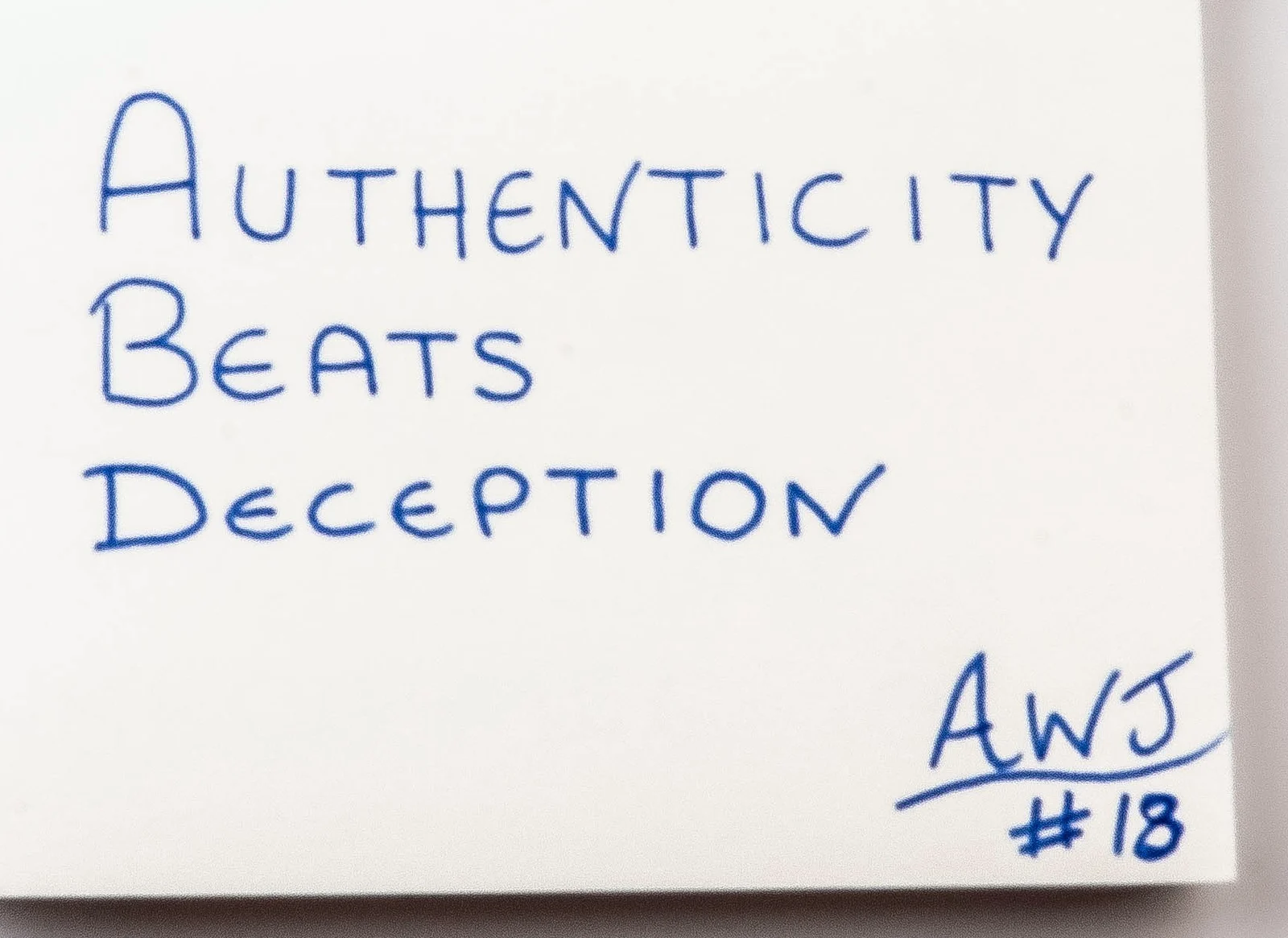 Handwritten in blue ink: Authenticity beats deception. Signed AWJ.